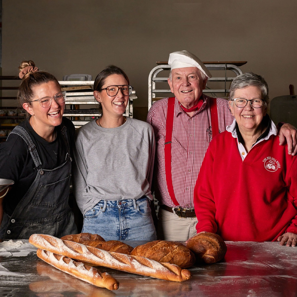 The Red Hill Baker family standing behind freshly baked bread