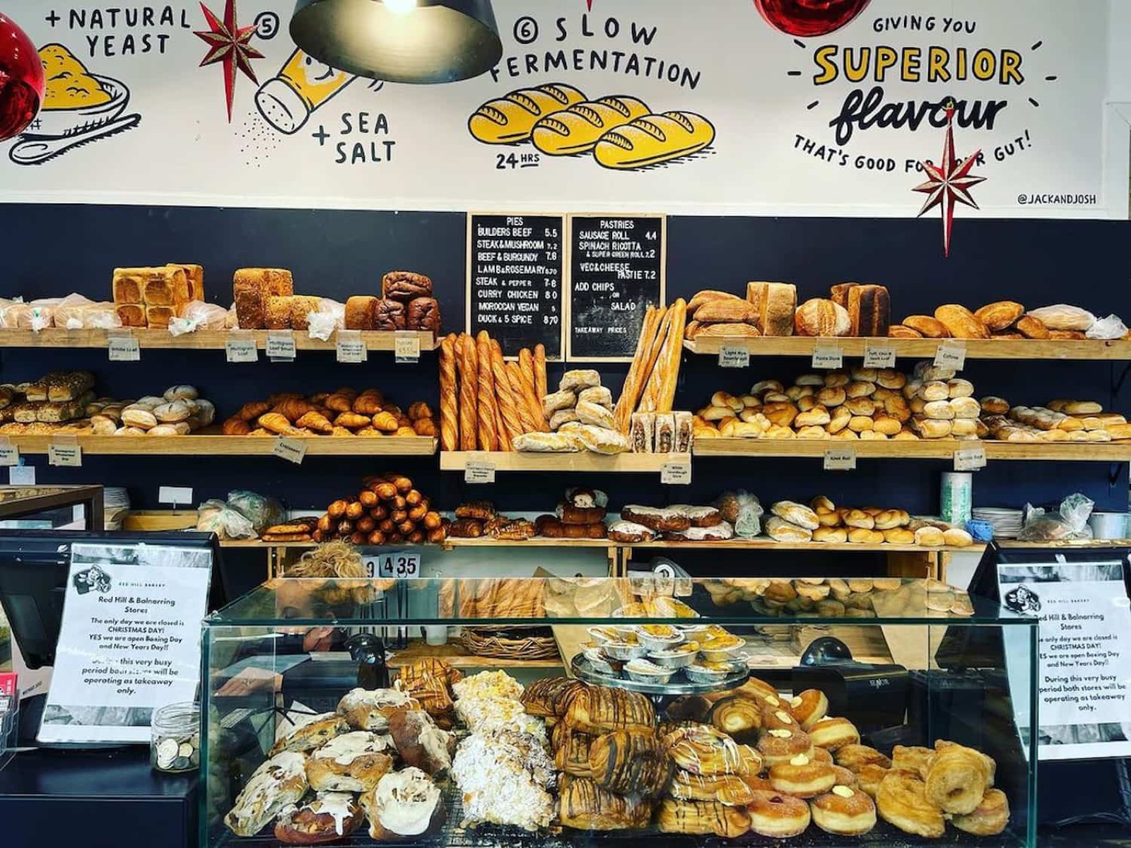 The bakery counter filled with bread, pastries and pies