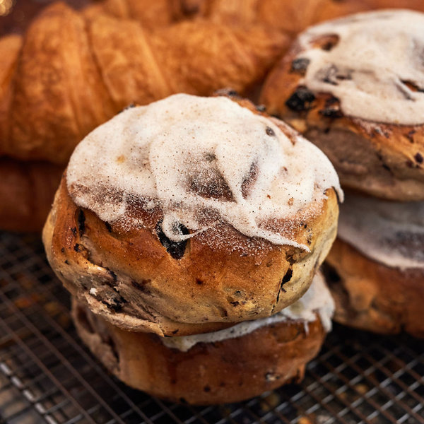 Fresh fruit buns and croissants cooling on a rack